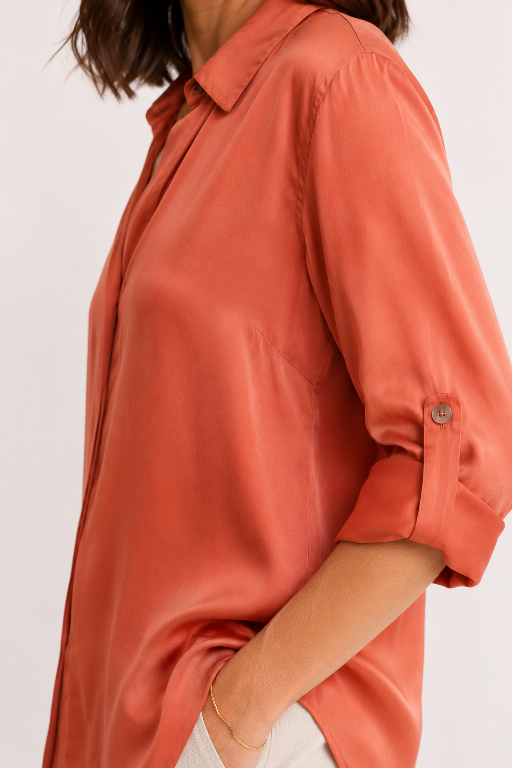 Coral-colored shirt worn by a person on a white background